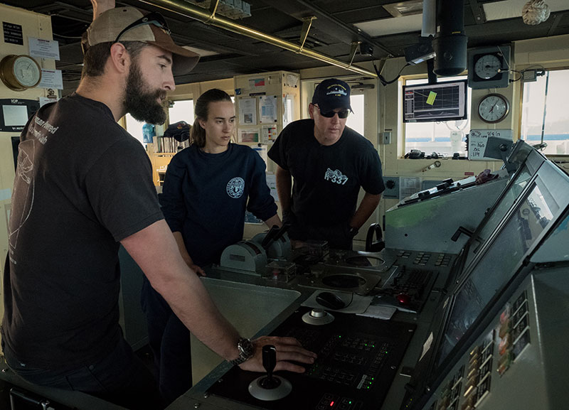 Kongsberg DP Technician, Michael Neal, provides training on use of the ship’s Dynamic Positioning system to NOAA Corps Officers ENS Anna Hallingstad and LT Aaron Colohon.