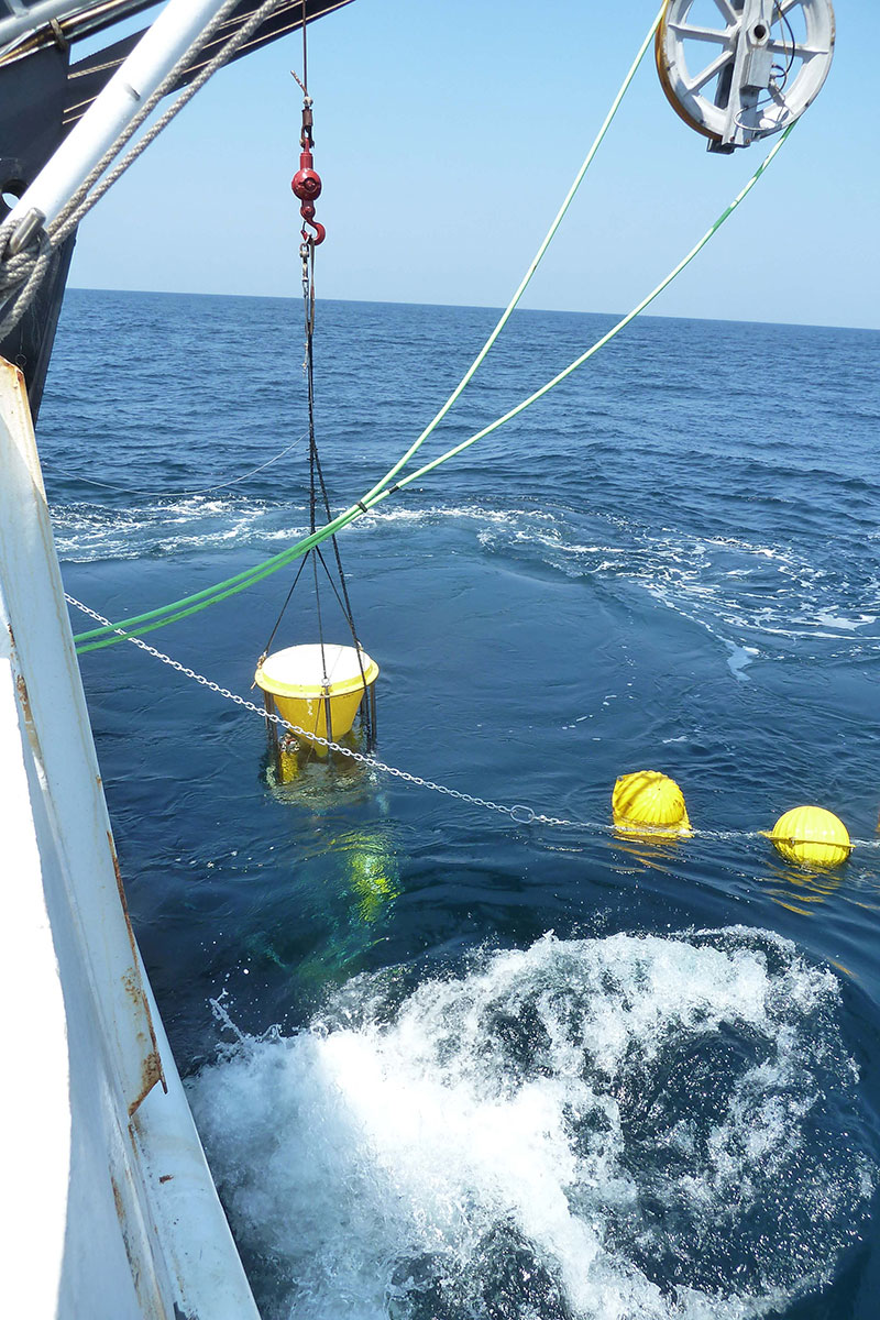 U.S. Geological Survey sediment trap and streaming floats being deployed off the stern of NOAA Ship Nancy Foster.