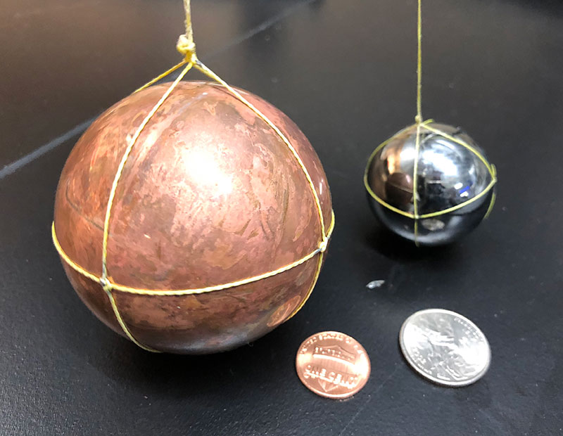 The 64-millimeter copper sphere (left) and 38.1-millimeter tungsten carbide sphere (right) used during NOAA Ship Okeanos Explorer Simrad EK60 split-beam transducer calibration.