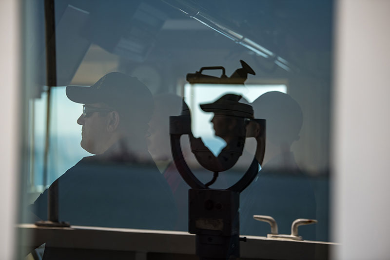 Crewmembers of NOAA Ship Okeanos Explorer on the bridge as the ship departs Pascagoula, Mississippi.