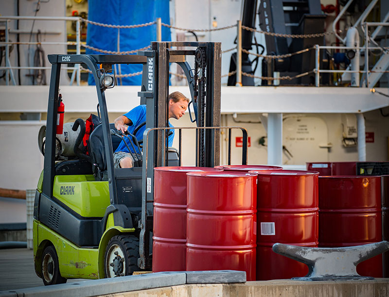 Chief Boatswain Jerrod Hozendorf loads some final stores before getting underway.