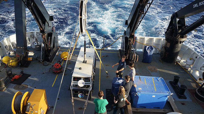 Todd talking to Team 3D about Seirios on the deck of the Okeanos.