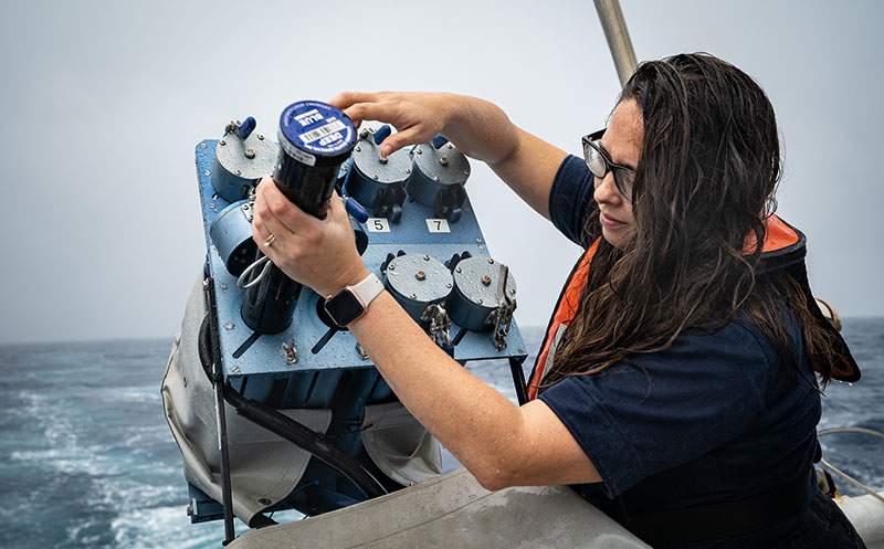 Mapping lead Shannon Hoy replenishes the expendable bathythermographs (XBTs) in the XBT autolauncher. These autolaunchers, designed by the NOAA Atlantic Oceanographic and Meteorological Laboratory, allow for XBTs to be automatically and remotely deployed by scientists either on a ship or on shore.