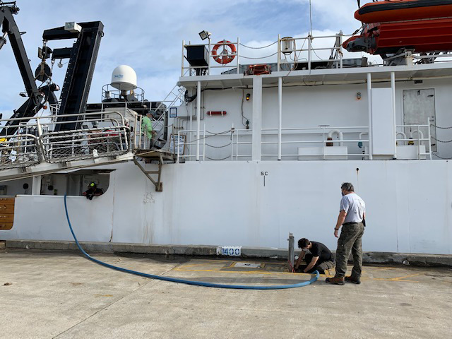 May 14, 2021. Ship engineers Pedro Lebron and Christian Lebron disconnect the potable water line in port before departure. The ship can hold up to 4,800 gallons of water which can be used in port and at sea before the reverse osmosis system, which makes potable water from seawater, is turned on.