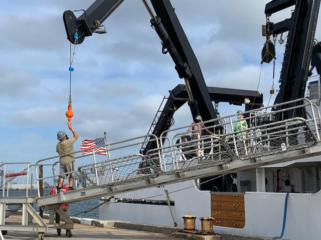 May 14, 2021. Ship engineers Pedro Lebron and Christian Lebron disconnect the potable water line in port before departure. The ship can hold up to 4,800 gallons of water which can be used in port and at sea before the reverse osmosis system, which makes potable water from seawater, is turned on.