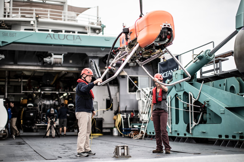 WHOI engineer Casey Machado (left) and NASA JPL engineer Russel Smith prepare Orpheus for a 2019 expedition