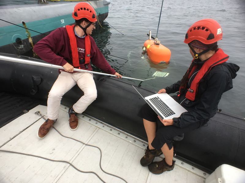NASA engineer Russell Smith and Woods Hole Oceanographic Institution engineer Molly Curran calibrate the cameras on Orpheus prior to a 2018 test dive