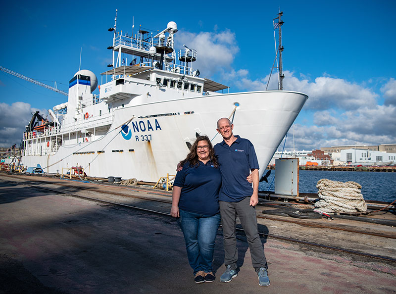 If you are tuning in to the live video during Windows to the Deep 2021 dives, you may wonder who you are listening to. Pictured here are our two on-ship science leads, Allen Collins and Stephanie Farrington, in front of NOAA Ship Okeanos Explorer before the start of the expedition. Take a moment to meet all of the explorers.