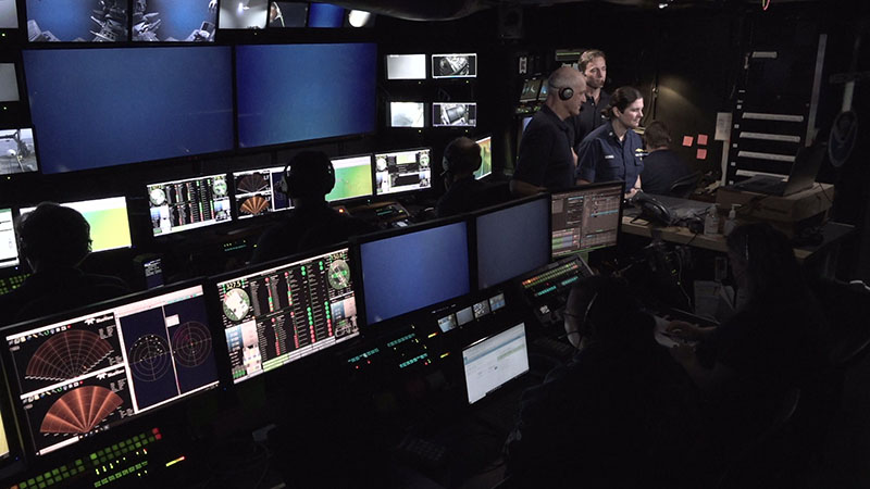 Commander Nicole Manning, Commanding Officer of NOAA Ship Okeanos Explorer; Derek Sowers, expedition mapping lead, NOAA Ocean Exploration; and Allen Collins, biology science lead, NOAA Fisheries National Systematics Laboratory Director participate in a virtual event from the control room of Okeanos Explorer during Windows to the Deep 2021. The event, which took place on November 5, was hosted by the White House Office of Science and Technology Policy, the Smithsonian National Museum of Natural History, and NOAA in order to highlight the importance and value of the ocean. Part of the event included this live conversation with explorers on the ship.