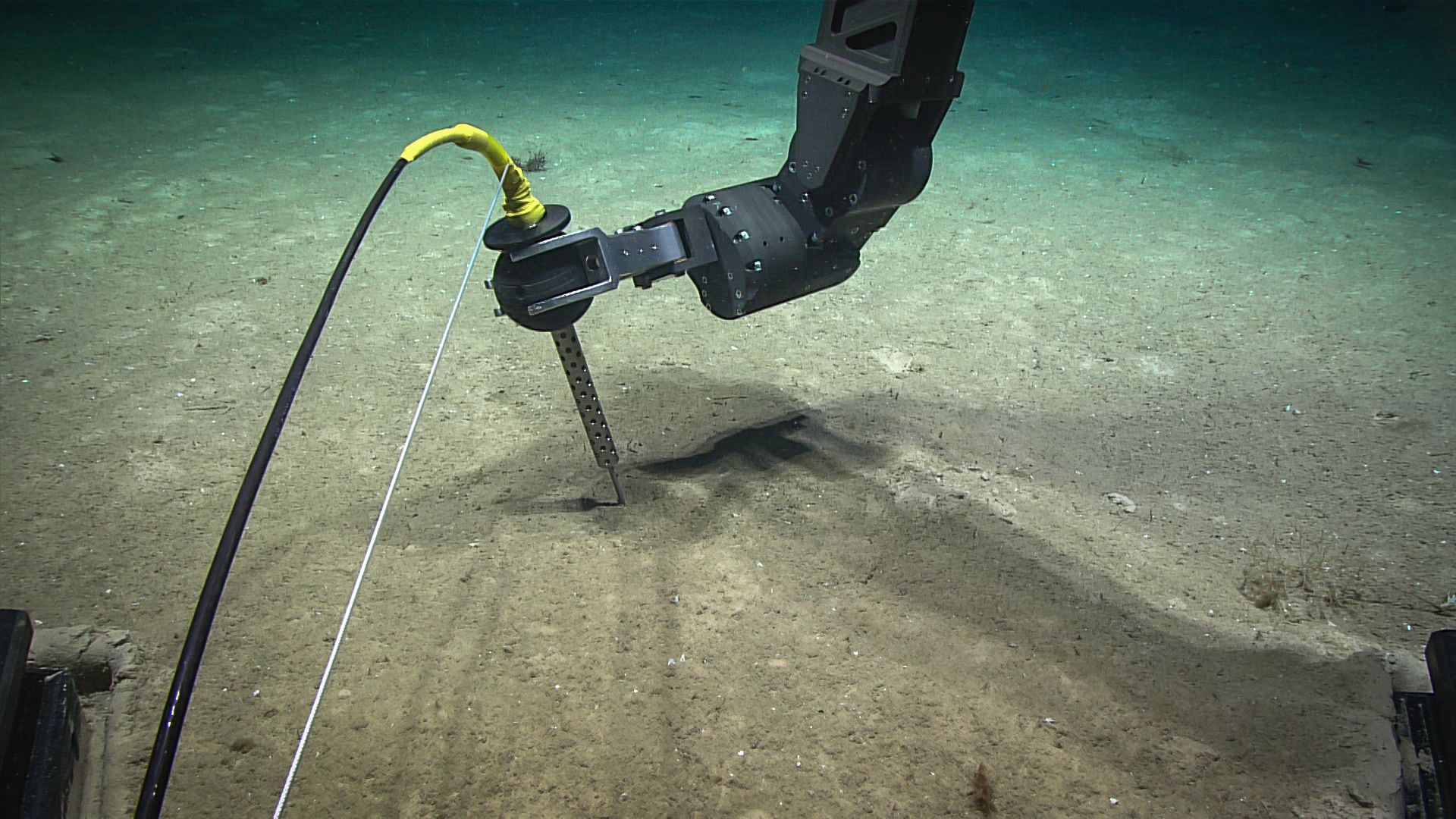 During Dive 03 of the 2022 ROV and Mapping Shakedown, remotely operated vehicle (ROV) pilots practiced with and tested ROV Deep Discoverer’s manipulator arm and temperature probe. We use the temperature probe to learn more about the biology and chemistry of the deep-sea environment, especially around hydrothermal vents, brine pools, and where hot water may be escaping from the seafloor.