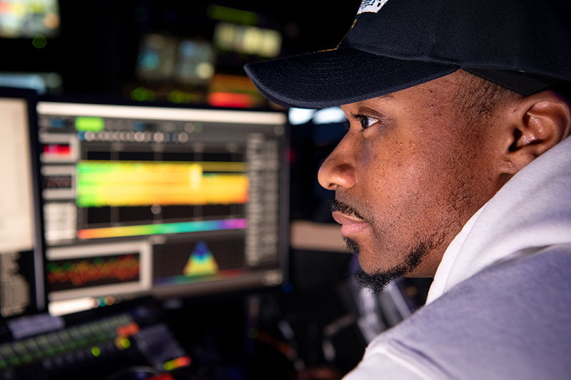 Daryin Medley, a NOAA Center for Coastal and Marine Ecosystems Graduate Scholar and graduate student at Florida Agricultural and Mechanical University, works to process multibeam bathymetry data as part of his Explorer-in-Training internship on NOAA Ship Okeanos Explorer during the 2022 Caribbean Mapping expedition.