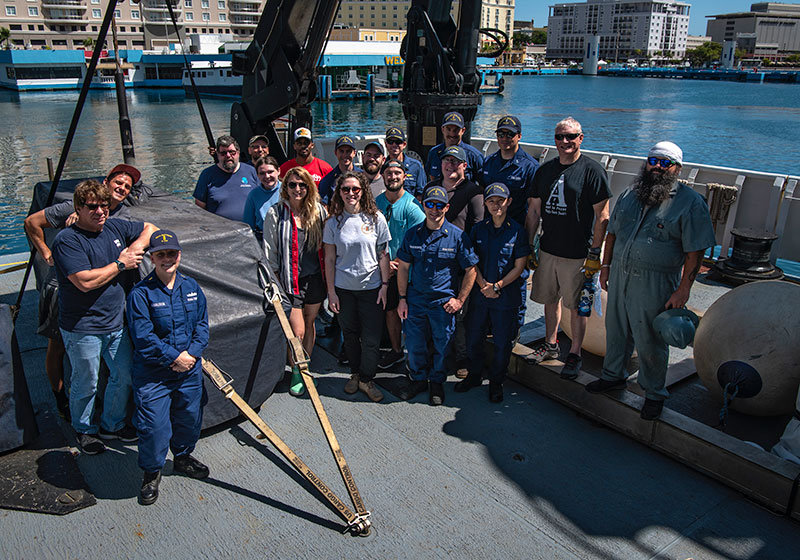 The team gathers on the deck of NOAA Ship Okeanos Explorer after the successful completion of the 2022 Caribbean Mapping expedition.