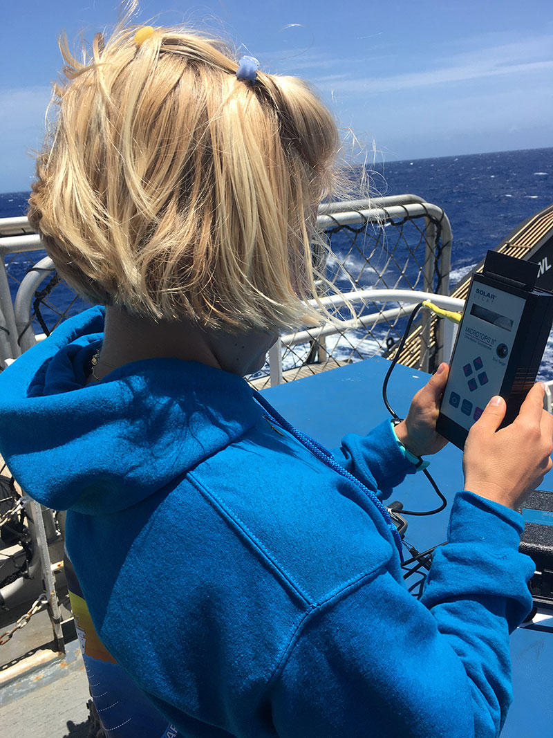 Maritime aerosol measurments can only be taken on clear, sunny days. Luckily, we've had plenty of them during the 2022 Puerto Rico Mapping and Deep-Sea Camera Demonstration. Here, Paige Hoel, an explorer-in-training uses a sunphotometer to collect data for NASA's Maritime Aerosol Network. Image courtesy of NOAA Ocean Exploration, 2022 Puerto Rico Mapping and Deep-Sea Camera Demonstration.