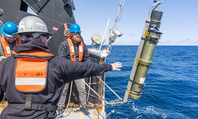 Global Foundation for Ocean Exploration engineers Lars Murphy and Sean Keninson prepare the USBL (ultra-short baseline) transponder for calibration. The USBL system is used to determine the position of remotely operated vehicles Deep Discoverer and Seirios while the vehicles are in the water. The calibration was designed to maximize the accuracy of the system. Learn more about USBL calibration.