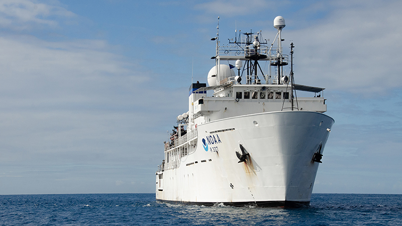 A large white research vessel on the ocean.