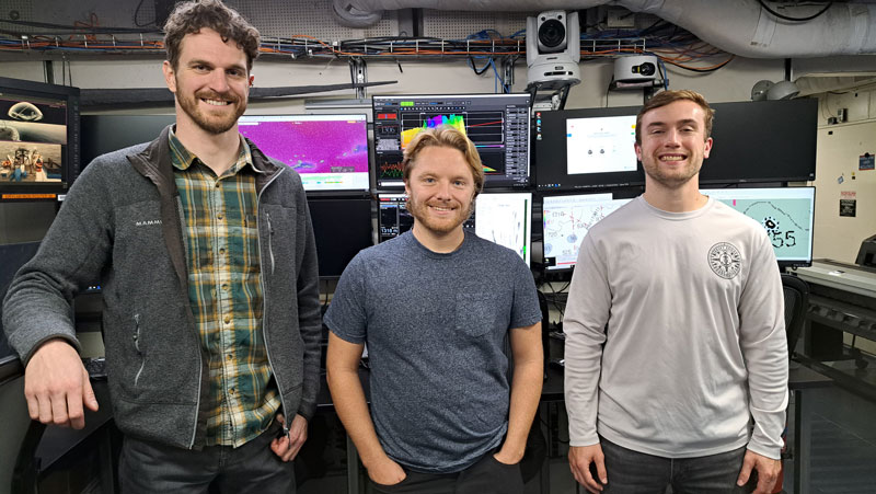 Explorers-in-Training Cameron Kuhle, Dana Carris, and Brett Woodworth onboard NOAA Ship Okeanos Explorer. [Right] Explorer-in-Training Ingrid Martinson participates in mapping data collection in the control room aboard NOAA Ship Okeanos Explorer.