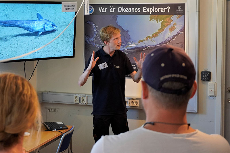 Science communicator Christian Nilsson, showing visitors a rattail fish in the deep-sea exhibit.