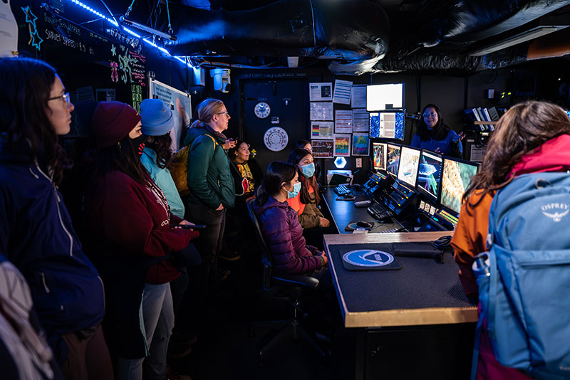 Seascape Alaska 3: Aleutians Remotely Operated Vehicle Exploration and Mapping expedition coordinator Shannon Hoy talks to visitors in the control room on NOAA Ship Okeanos Explorer.