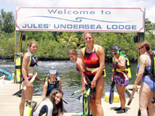 Girl Scouts readying their gear to SCUBA dive to the Jules Verne Undersea Lodge.