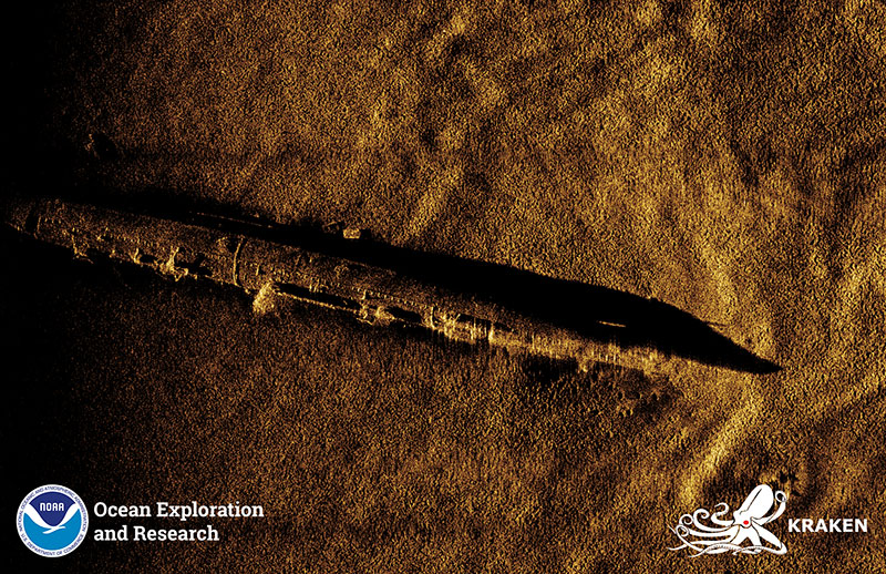 Synthetic Aperture Sonar imagery of the <em>USS L-8</em>, developed using data collected using the KATFISH™ system. The submarine is largely intact and appears to be resting on its port side. Sections of the outer hull are missing, likely caused when the vessels propellers were removed in the late 1980s.