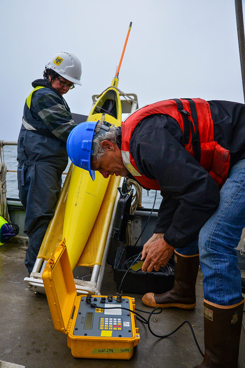 Captain Eric Boget from the Coordinated Simultaneous Physical-Biological Sampling Using ADCP-Equipped Ocean Gliders expedition communicates with a moored echosounder system that is attached to the seafloor. This box allows the team to communicate with an acoustic release device that is connected to the echosounder that they would like to recover. Once Eric sends the signal (an acoustic ping at a specific frequency) down to the acoustic release, the echosounder will pop to the water’s surface. 