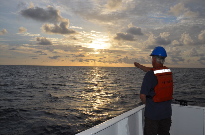 A member of the glider team, John Horne, keeps an eye on the glider’s position in the distance. Meanwhile, other glider team field personnel are in the small boat, en route to retrieve the glider.