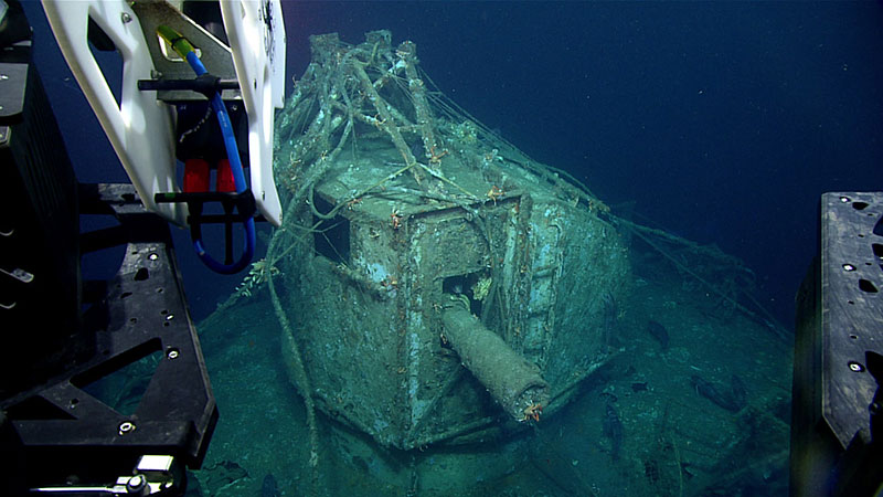 Image from ROV Deep Discoverer of the ship gun fire-control system with the base of antenna array and cylindrical range finder located above the pilot house. The ship gun fire control system is the highest point of the wreck. Image was taken from the starboard side of the Baldwin, facing port. Bow is orientated to the right of the image. Note the derelict fishing gear on the wreck.