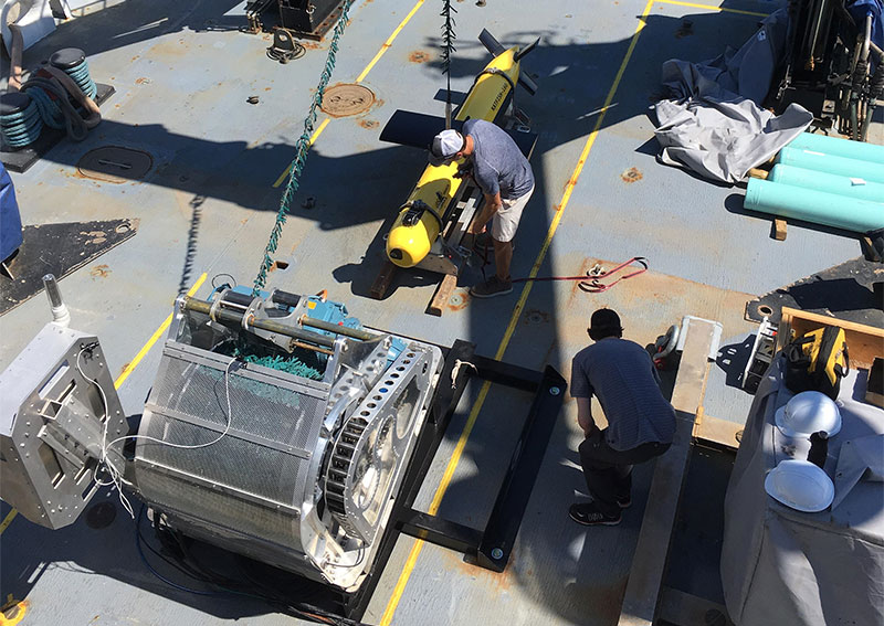 Operations personnel from ThayerMahan, Inc. and Kraken Robotics integrating the KATFISH on the back deck of the Okeanos Explorer.