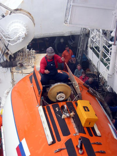 A Mir technician manually inspects the O-ring that will keep the scientists from being exposed to the elements at 3800 meters below the sea surface.