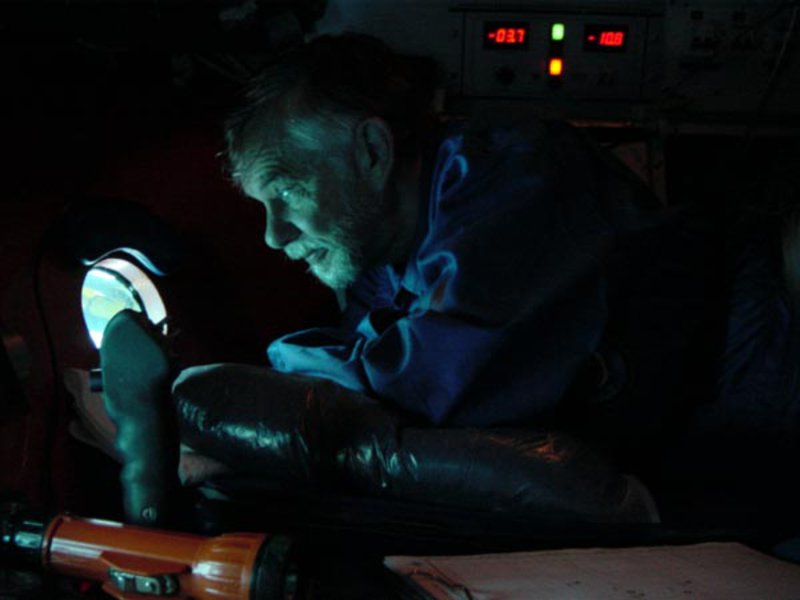 While preparing for his 9-hour expedition in the submersible, Dr. Roy Cullimore peers out of the porthole on Mir 1 on the way down to Titanic.