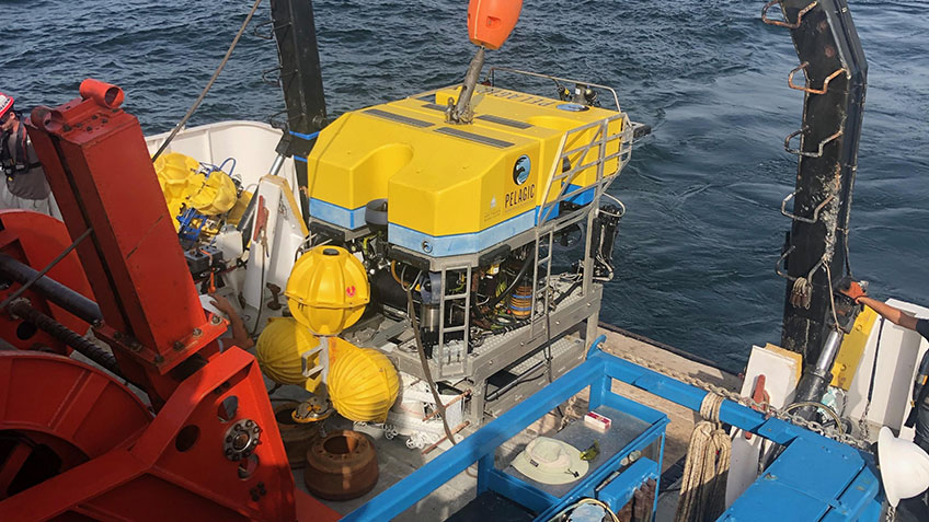 ROV Odysseus being deployed while carrying an acoustic lander with attached microbial recruitment experiments for deployment on the seafloor.