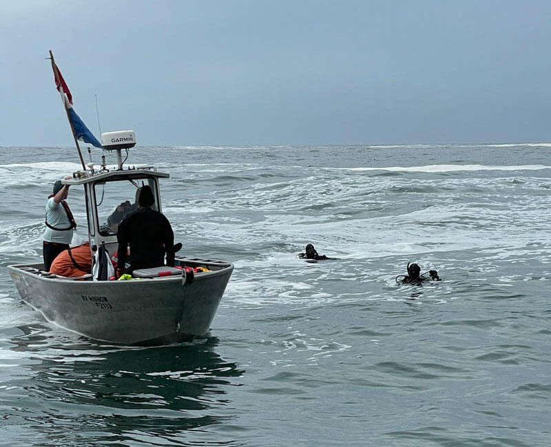 Divers and Research Vessel Minnow during the search for shipwrecks in Olympic Coast National Marine Sanctuary.